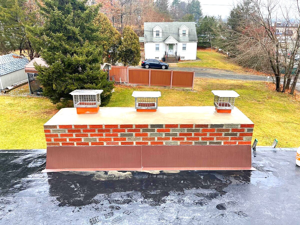 Brick chimney with a fitted metal cap