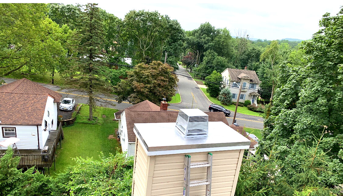 Metal chase cover installed over a chimney enclosure