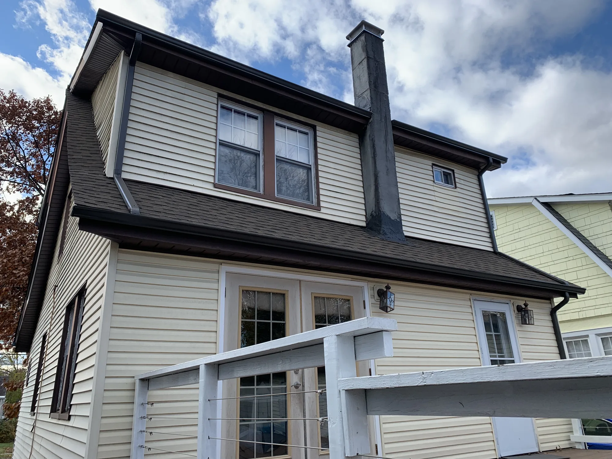 Exterior view of a chimney extending above a residential roof