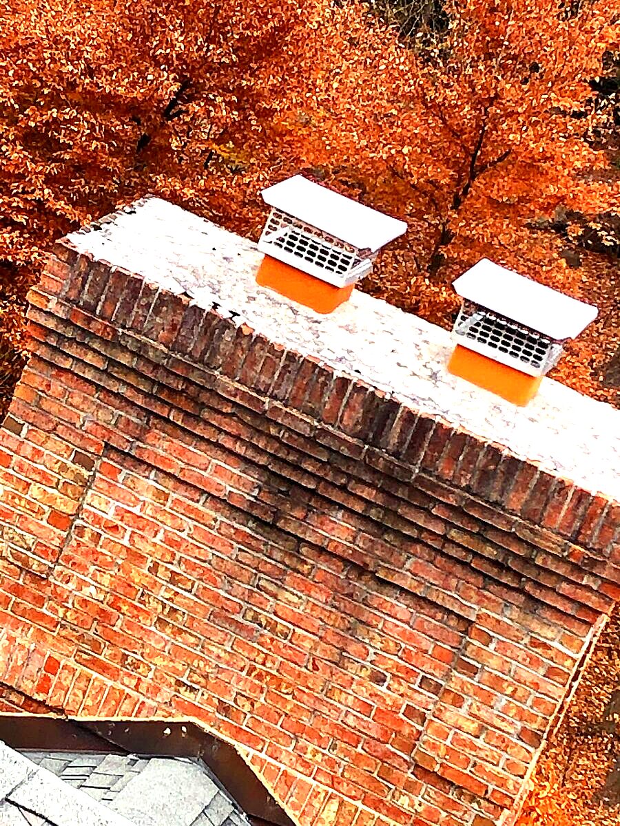 Chimney cap and brickwork at an exterior roofline