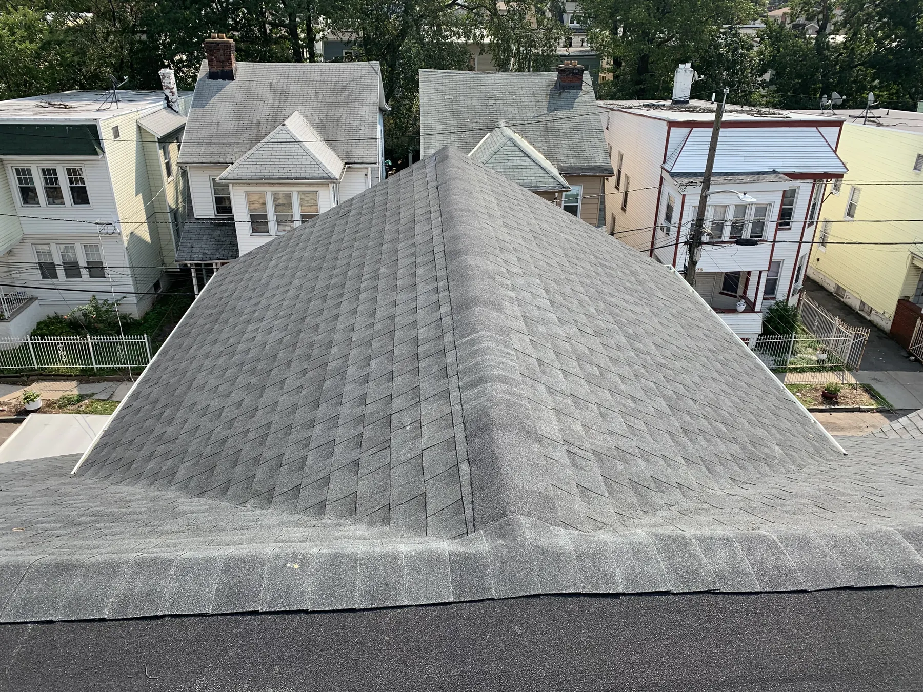 Completed asphalt shingle roof viewed across the main roof surface
