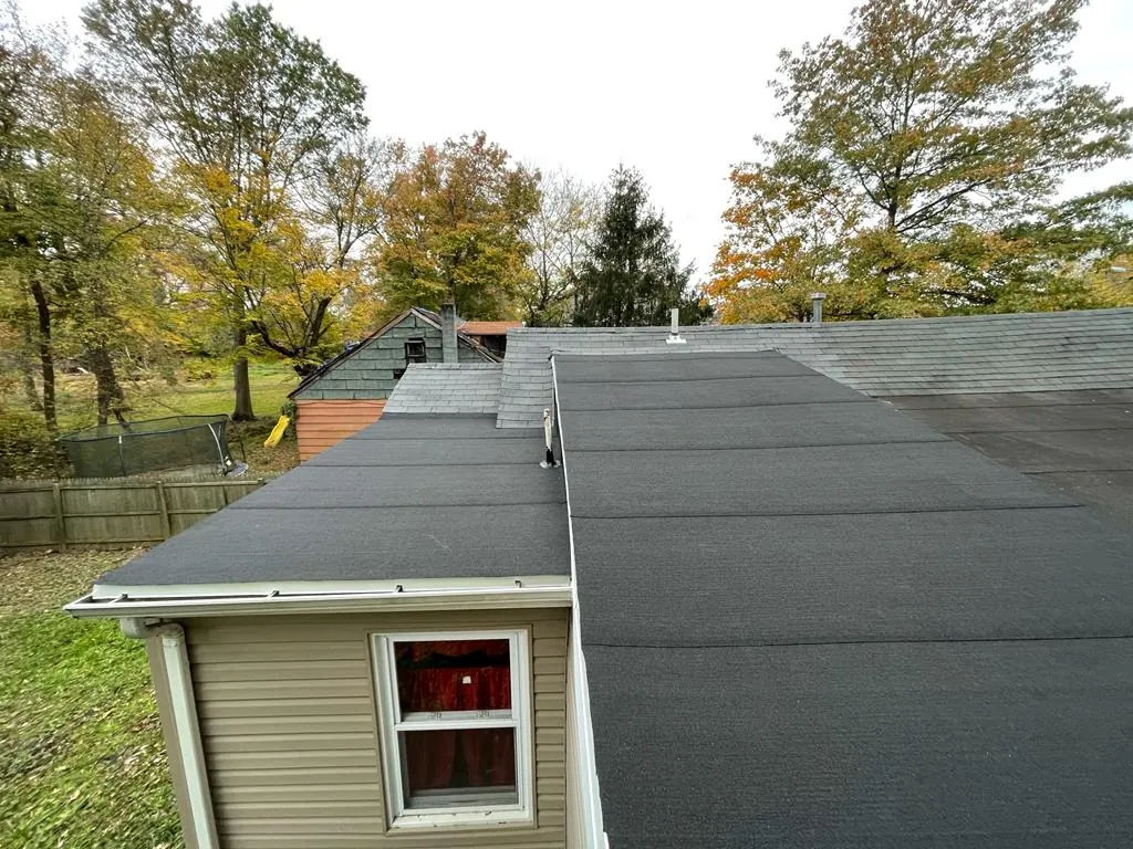 Dark cap-sheet roof covering on a low-slope addition