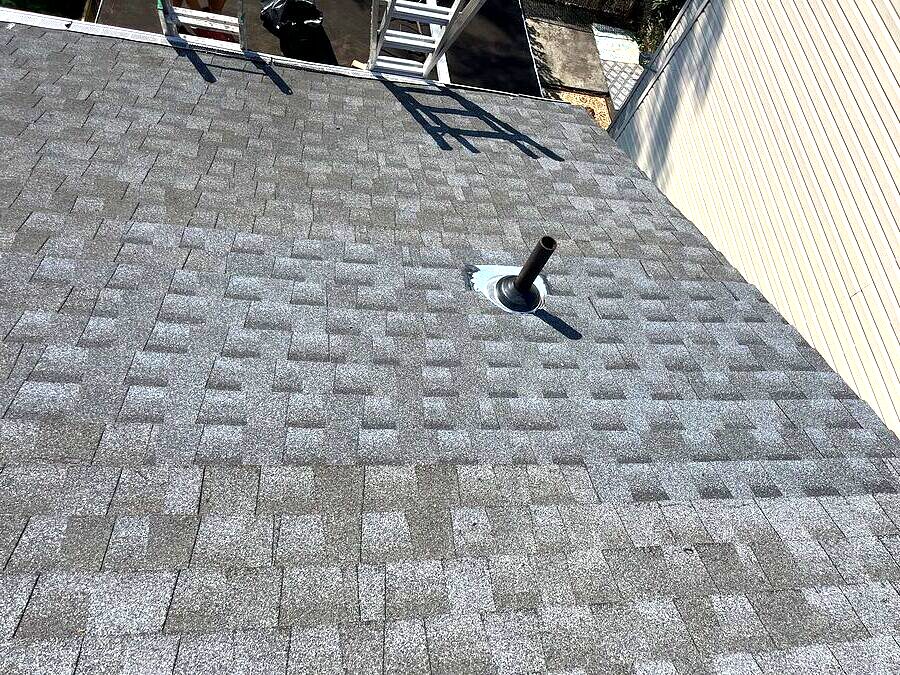 Roof surface with shingles and roof penetration