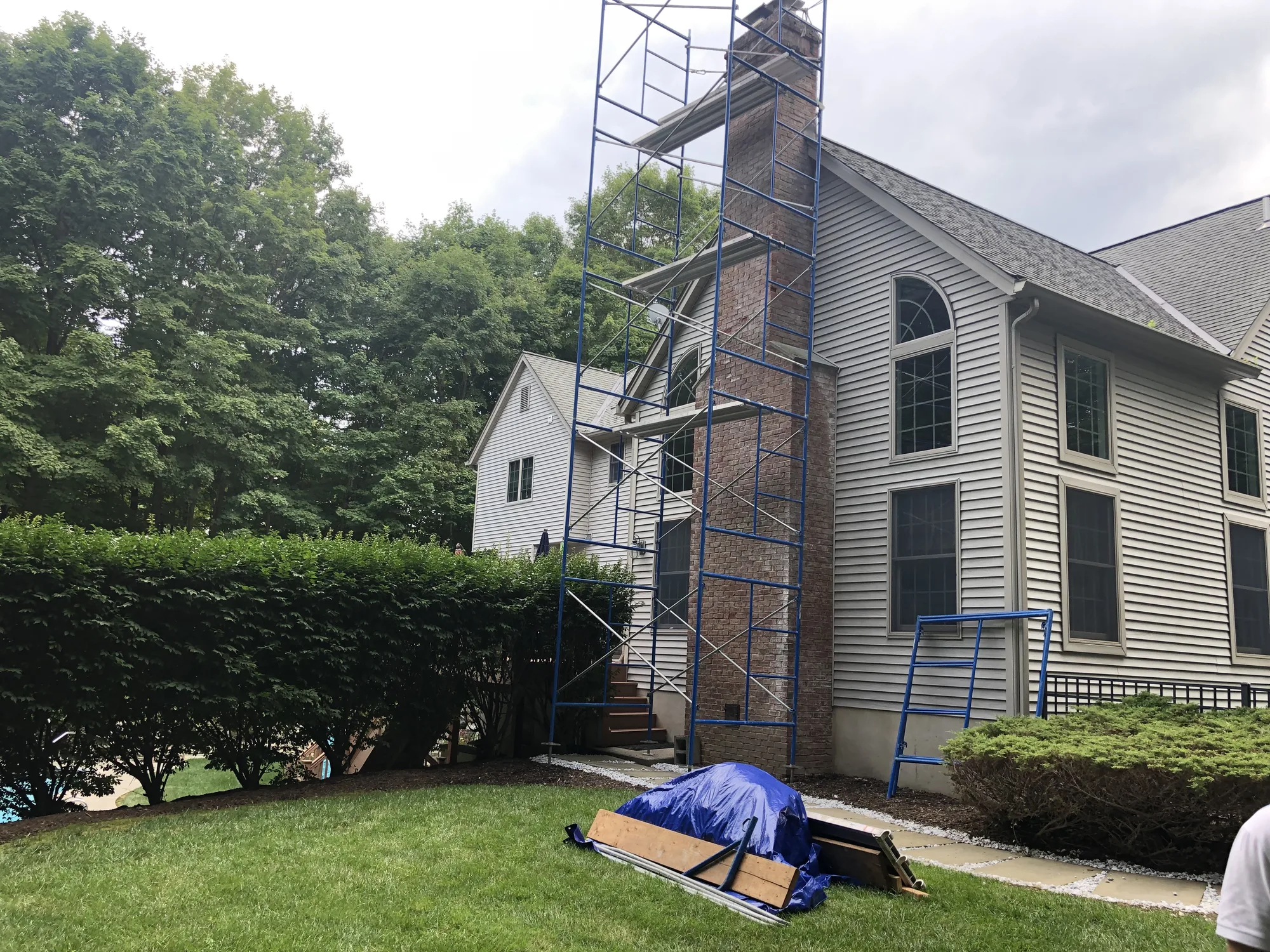 Tall brick chimney surrounded by access scaffolding
